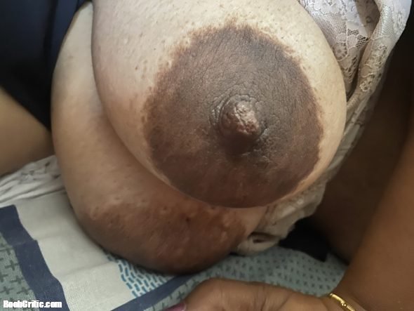 Close up of pregnant wife’s huge boobs with chocolate nips full of milk